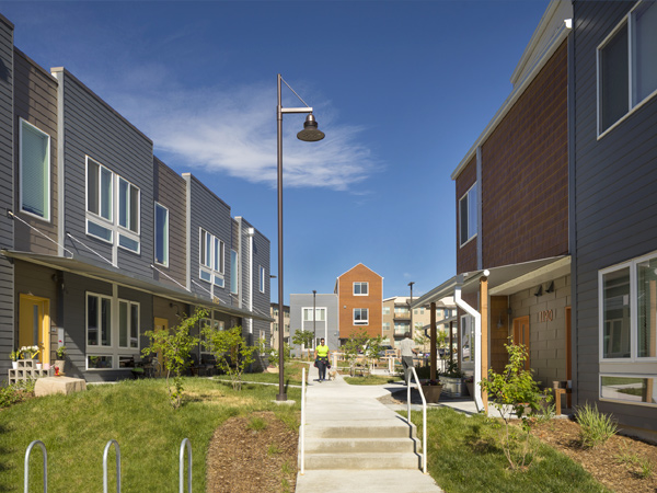 Image of two-story townhomes surrounding a walking path.